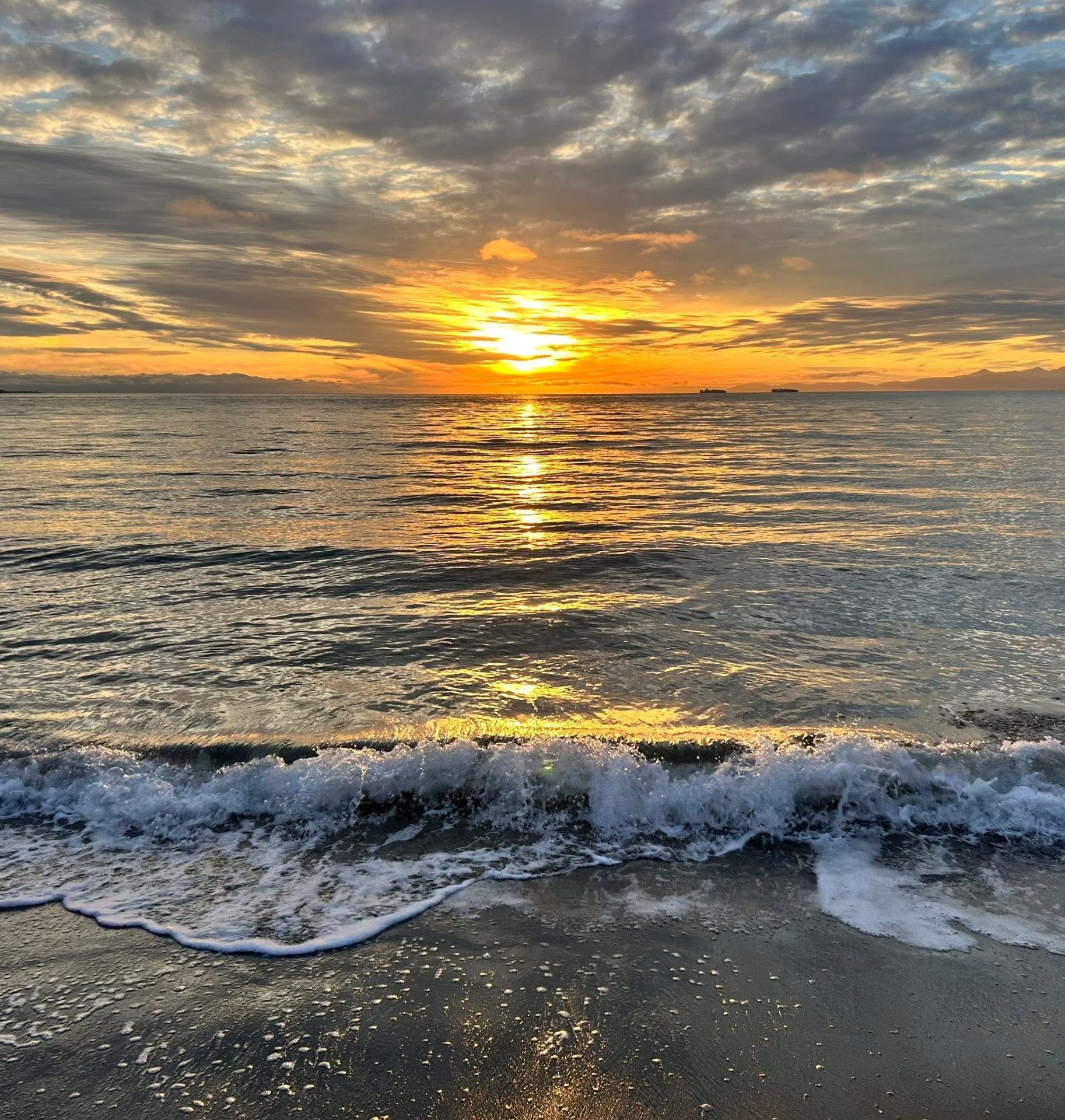 Sunset waves rolling onto a Colwood beach